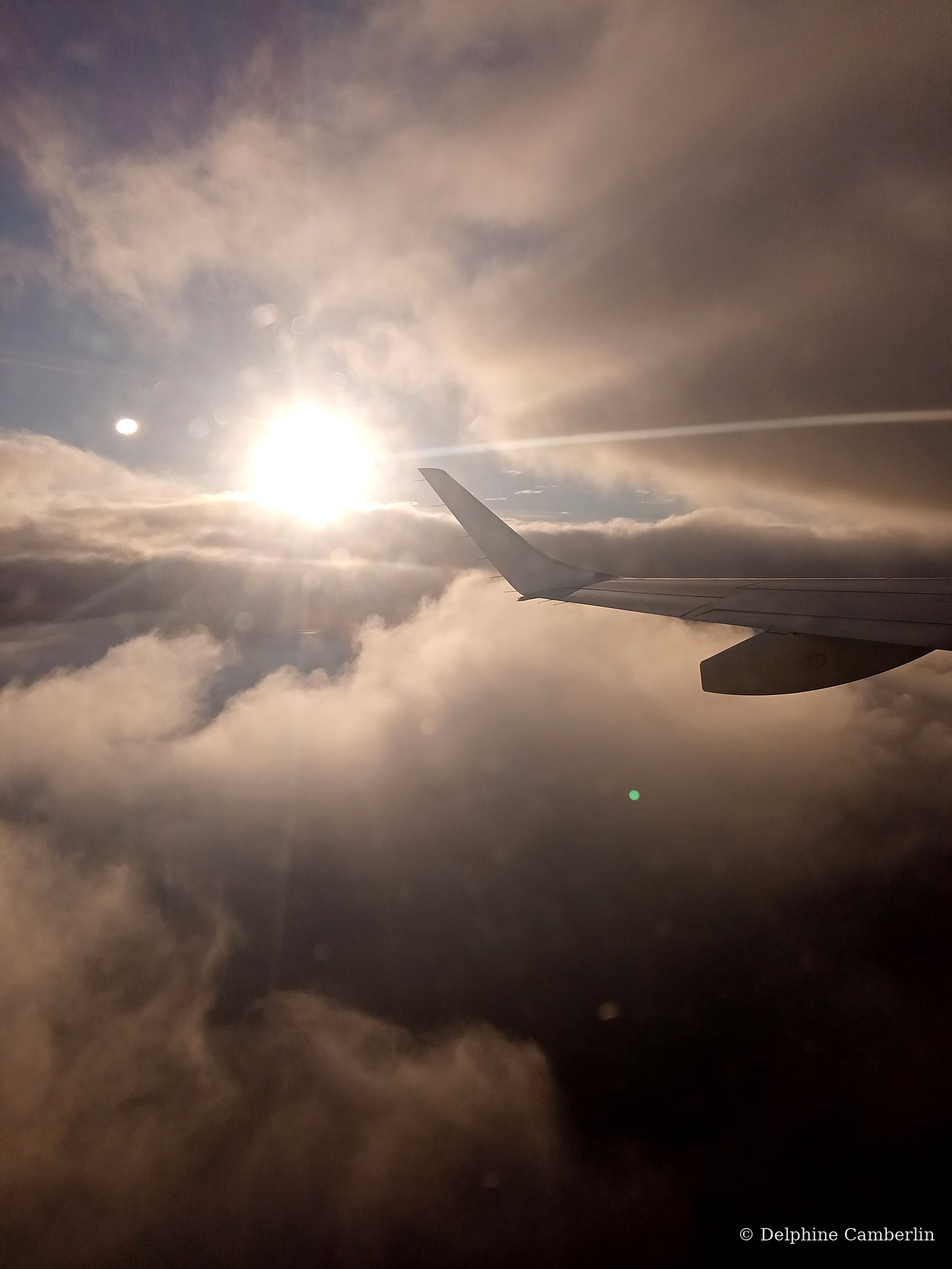 Plane wing dramatic sky — avoid airline offsets