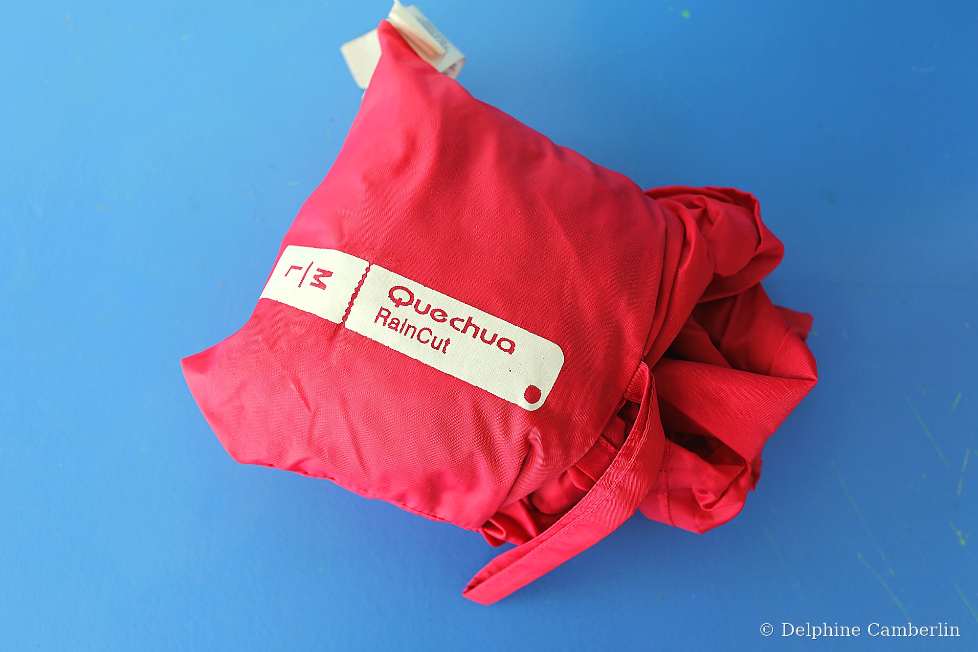 Packable rain jacket folded with label visible