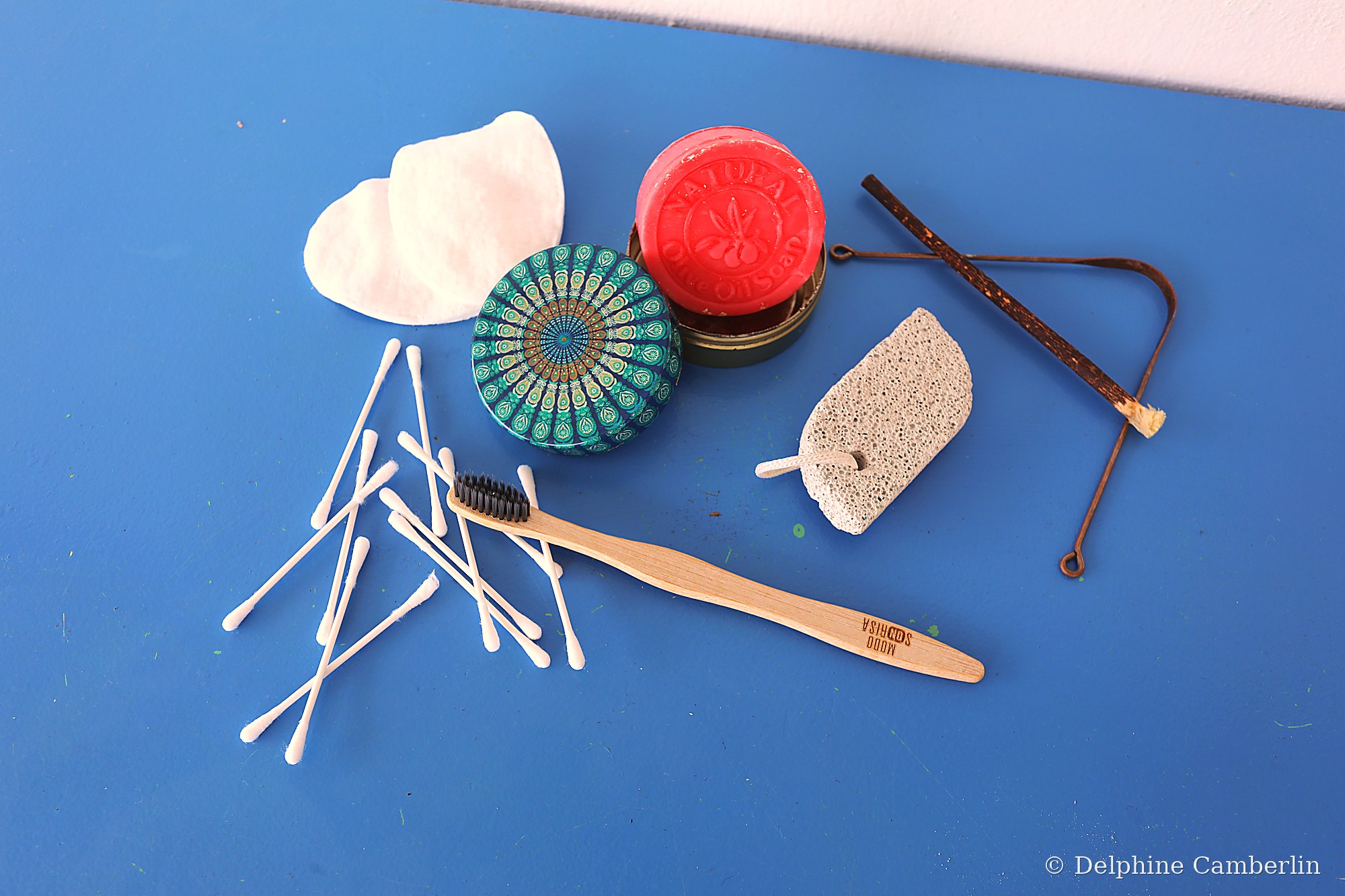 Solid shampoo, soap bar, wooden toothbrush and cotton swabs flat lay