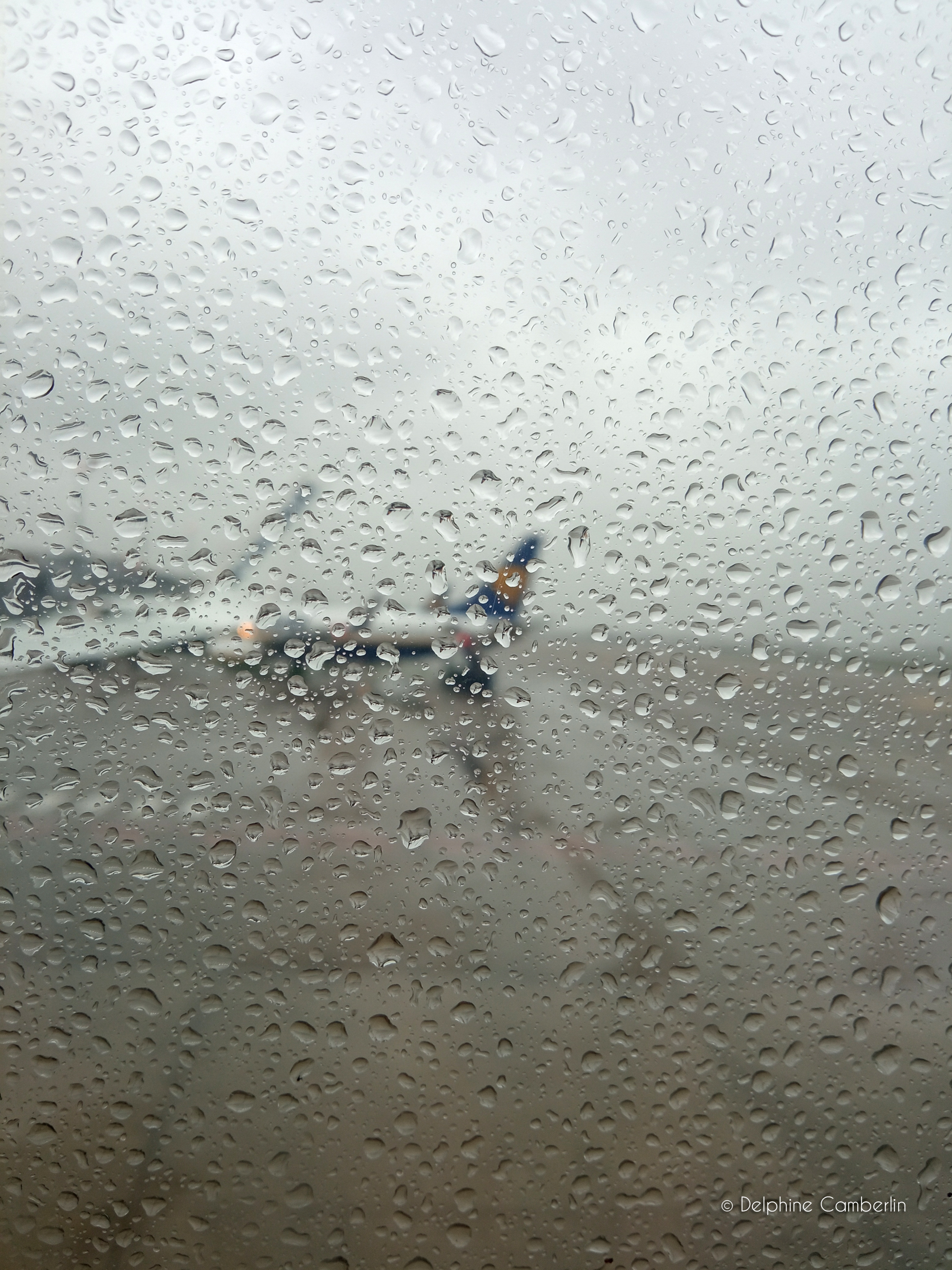 Travel insurance guide — view from plane above clouds