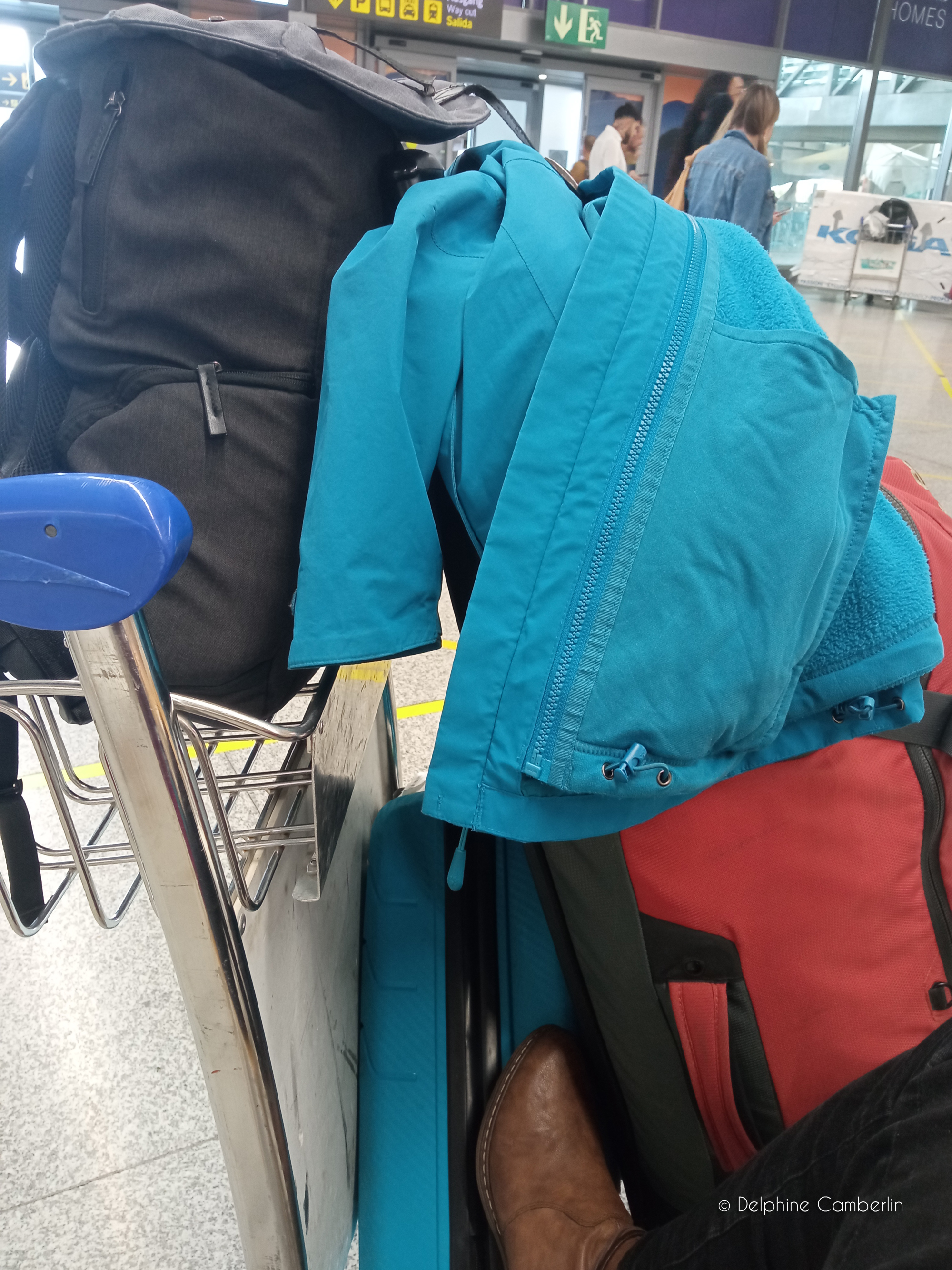 Luggage trolley loaded with bags at an airport — compare travel insurance before every departure