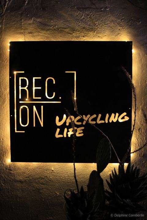 REC.ON Co-living, Vélez-Rubio, Spain – “Upcycling Life” sign lit at night